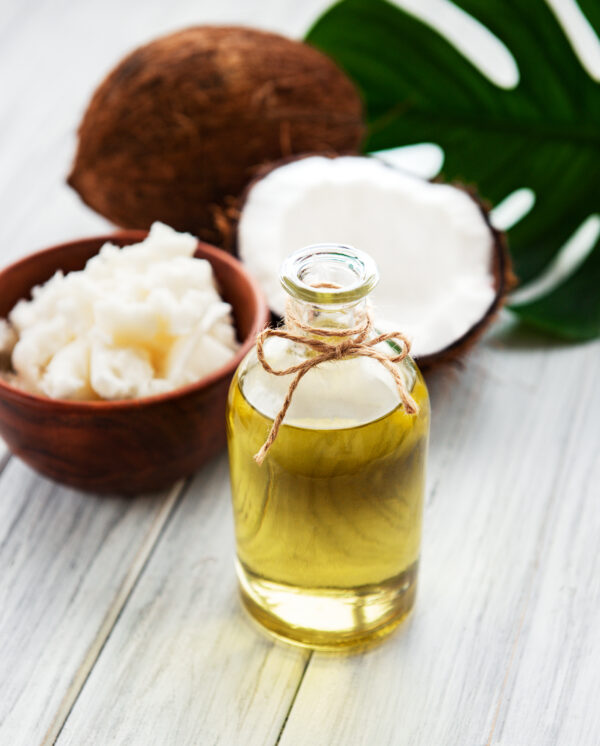 Fresh coconut oil and coconuts on a old wooden table